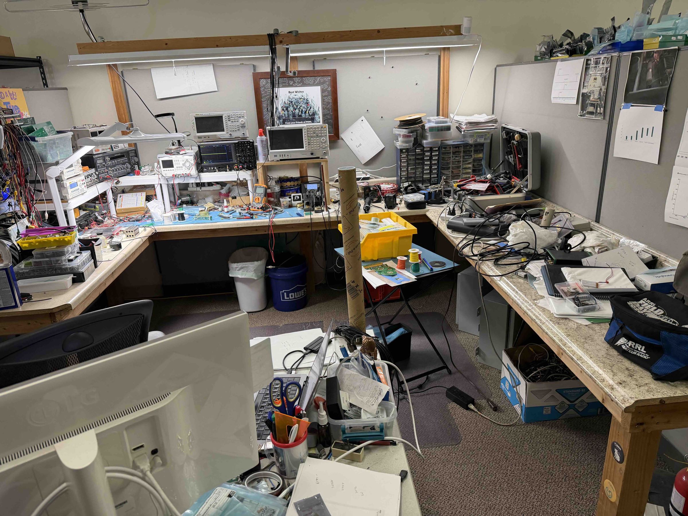 Electronics R&D laboratory with oscilloscopes, spectrum analyzer, and active development bench