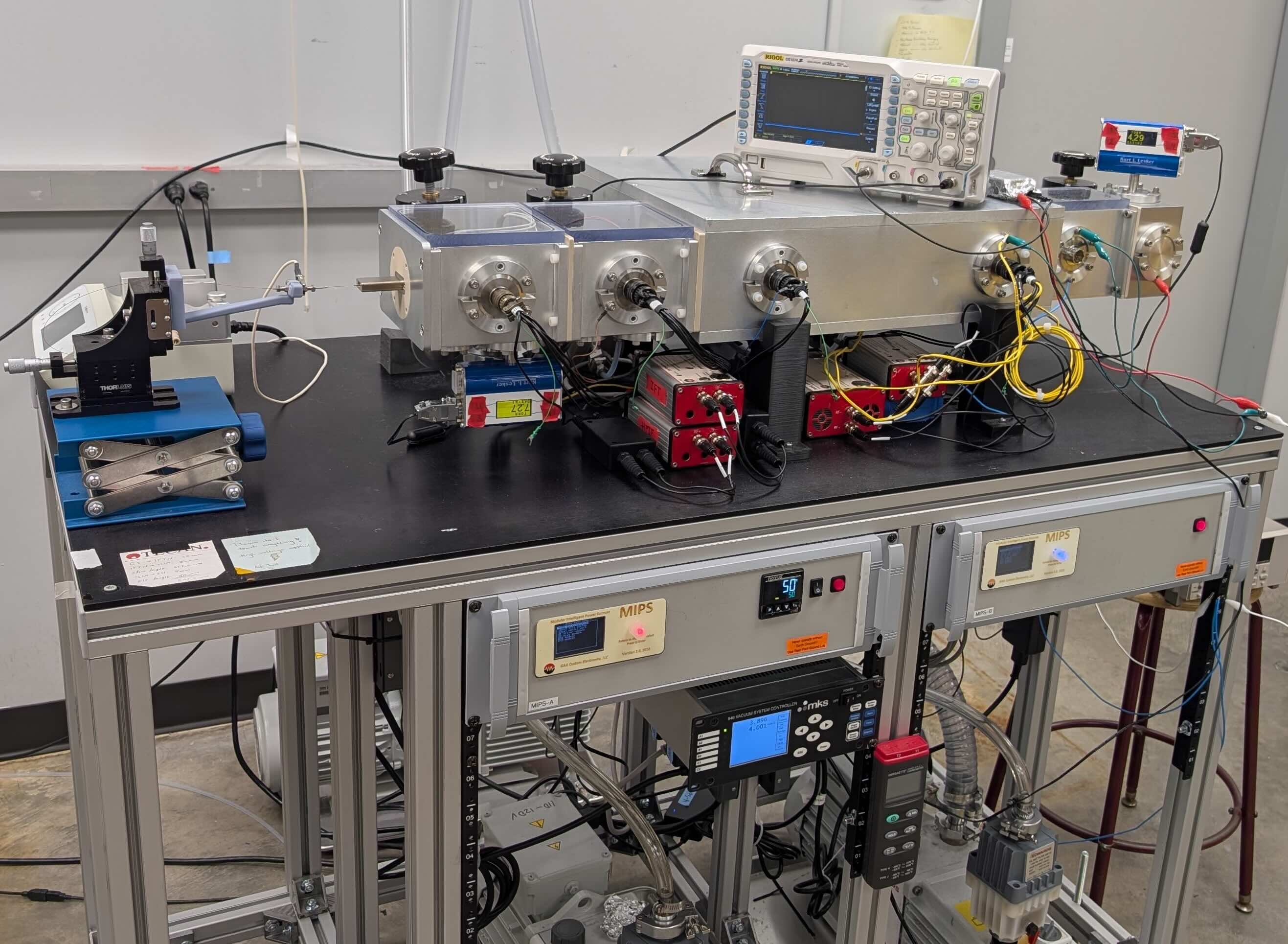 IMS research platform at Auburn University — Dr. Ahmed M. Hamid lab — showing two MIPS systems, custom ion funnels, and electrometer on aluminum extrusion cart