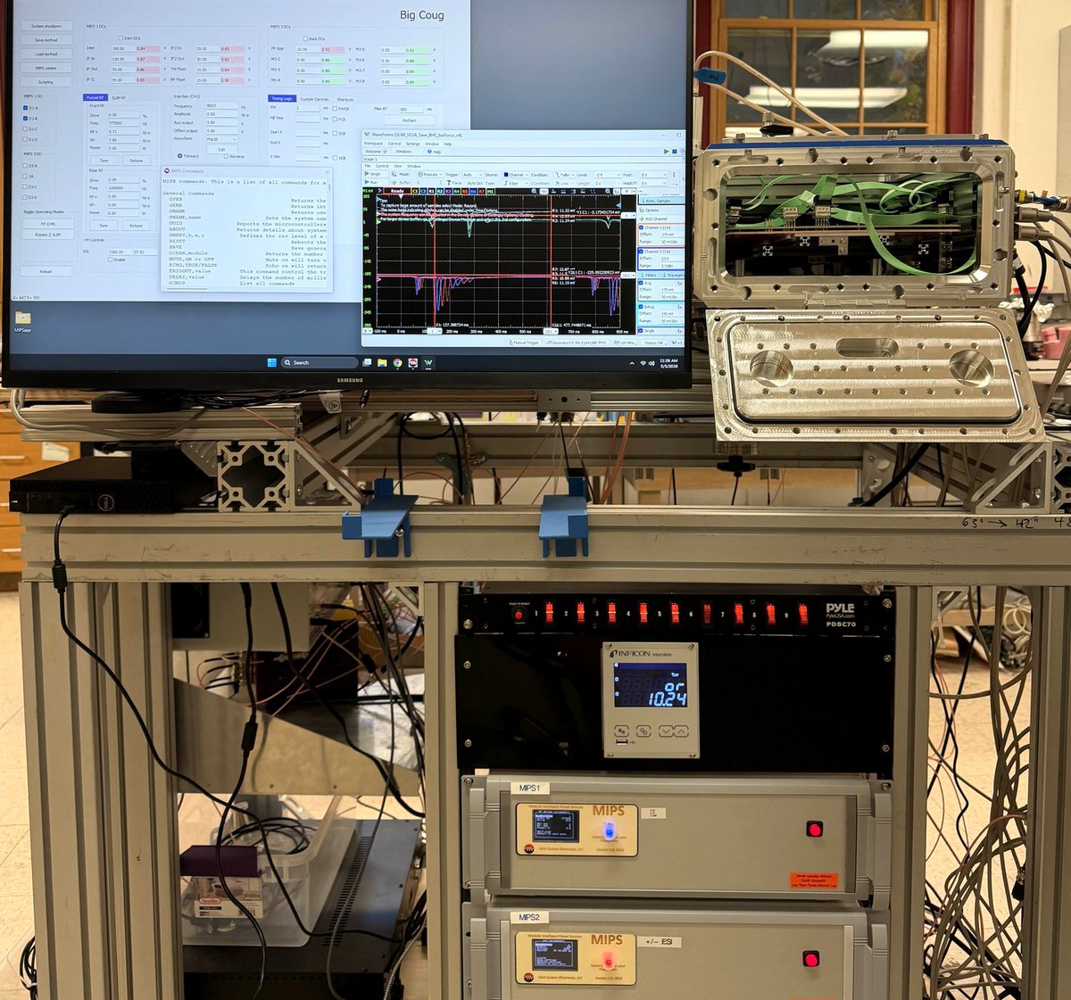 Washington State University 8-meter SLIM system showing 3 MIPS controllers in rack, custom control panel on monitor with live oscilloscope trace, and SLIM vacuum hardware